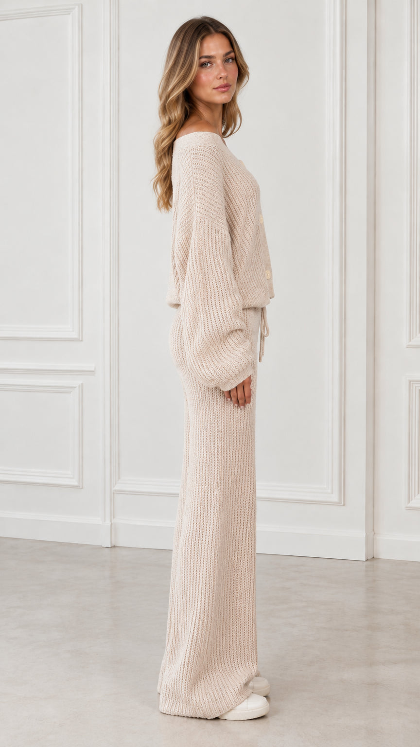 Side profile view of woman wearing beige ribbed knit two piece sweater and pants set