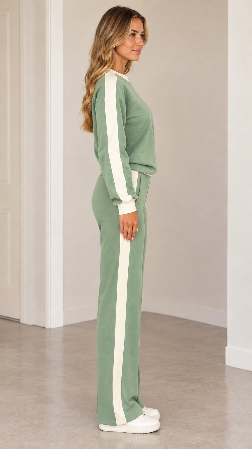 Side profile view of woman wearing sage green 2-piece side stripe loungewear set