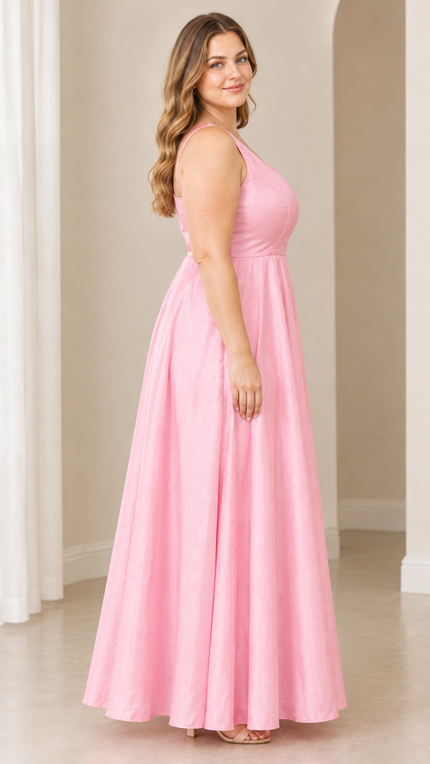 Side profile view of woman wearing pink sleeveless formal maxi dress
