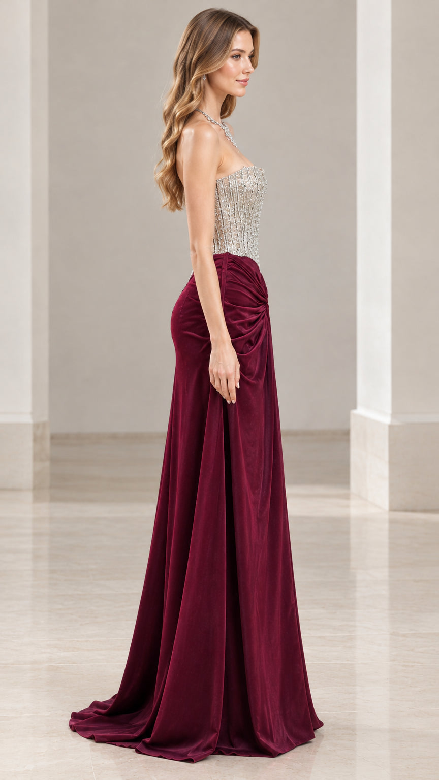 Side profile view of woman wearing strapless burgundy formal maxi gown