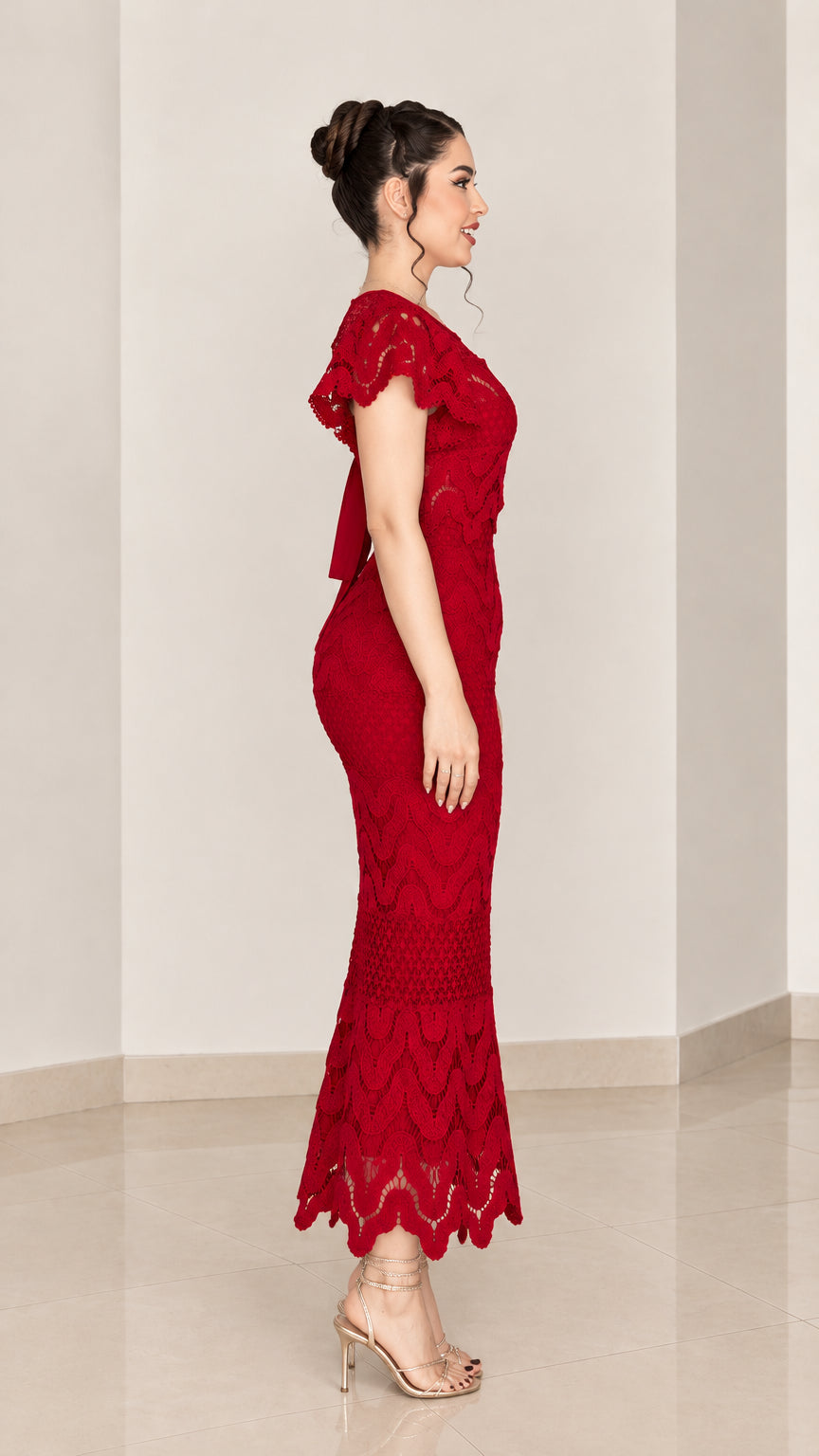 Side profile of woman in red lace mermaid dress showing silhouette