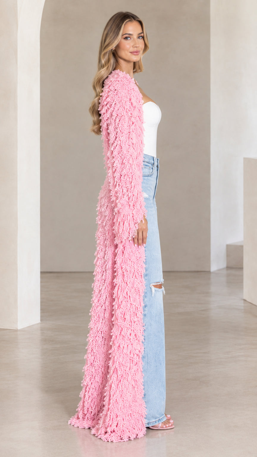 Side profile of pink textured maxi duster cardigan showing floor-length drape