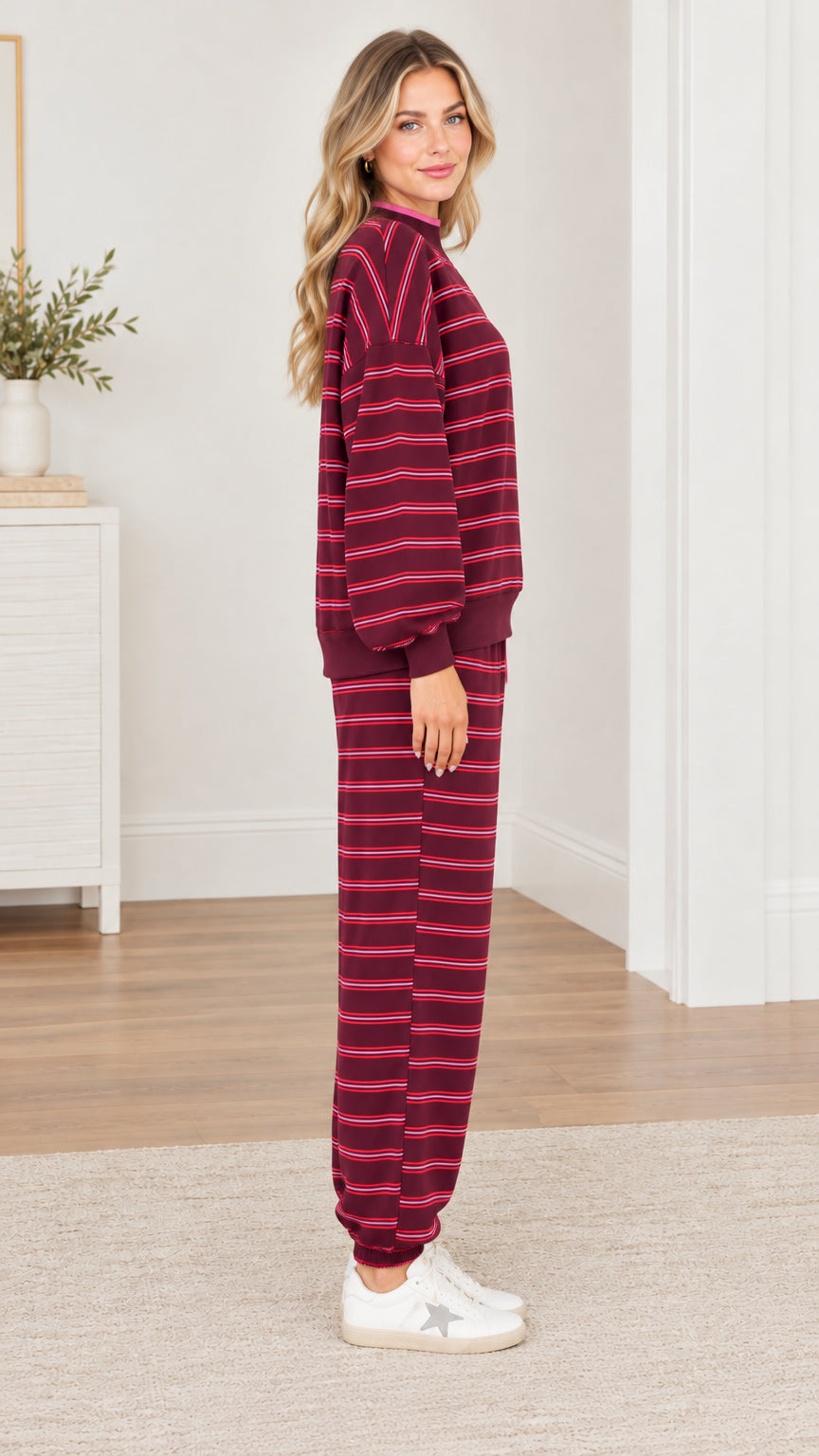 Side profile view of woman wearing burgundy striped 2-piece loungewear set