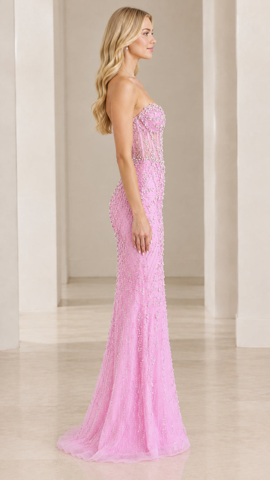 Side profile view of pink strapless embellished corset formal dress