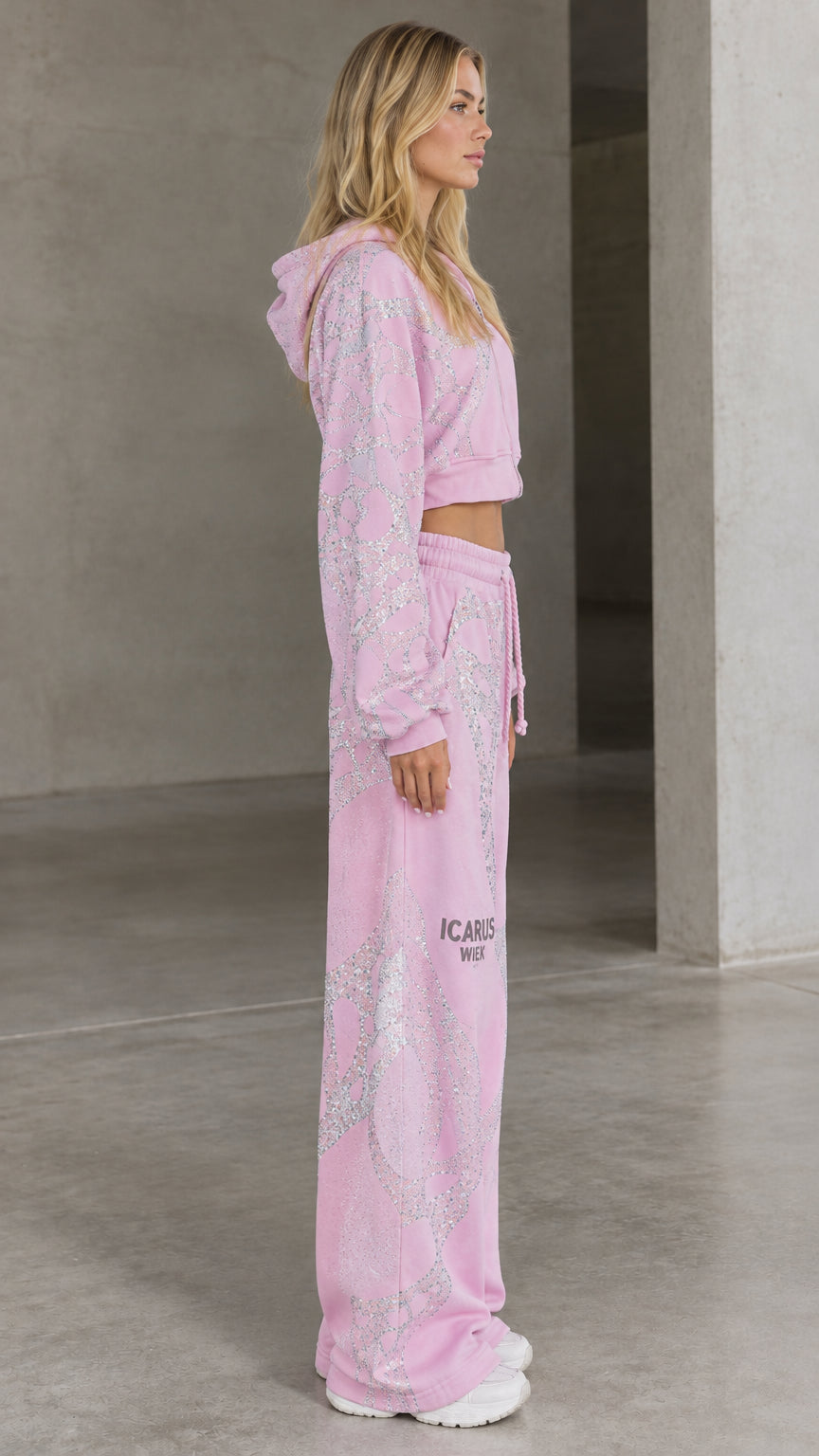 Side profile view of pink rhinestone embellished two-piece tracksuit set