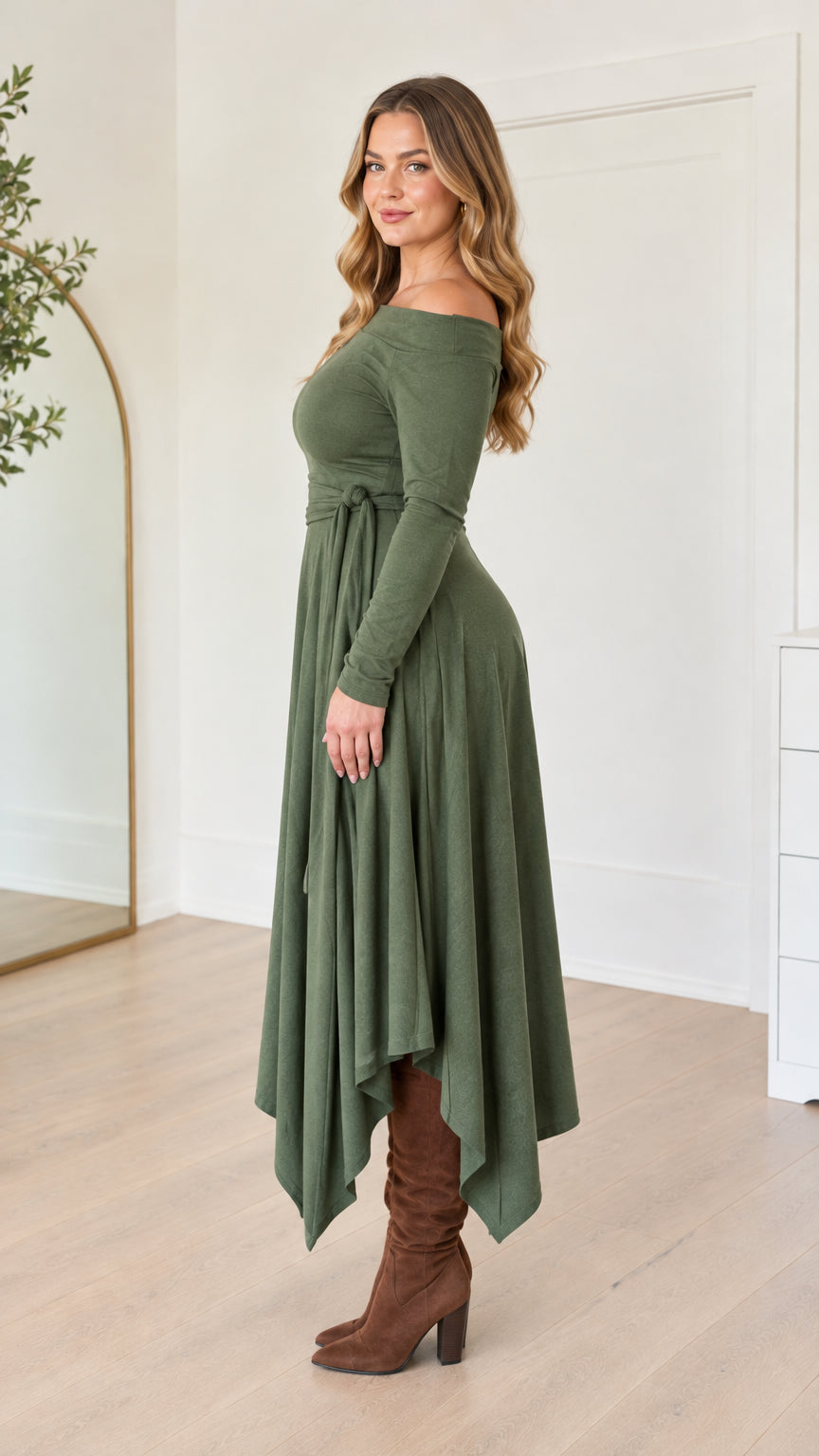 Side full-length view of woman wearing the olive green off-the-shoulder long sleeve dress