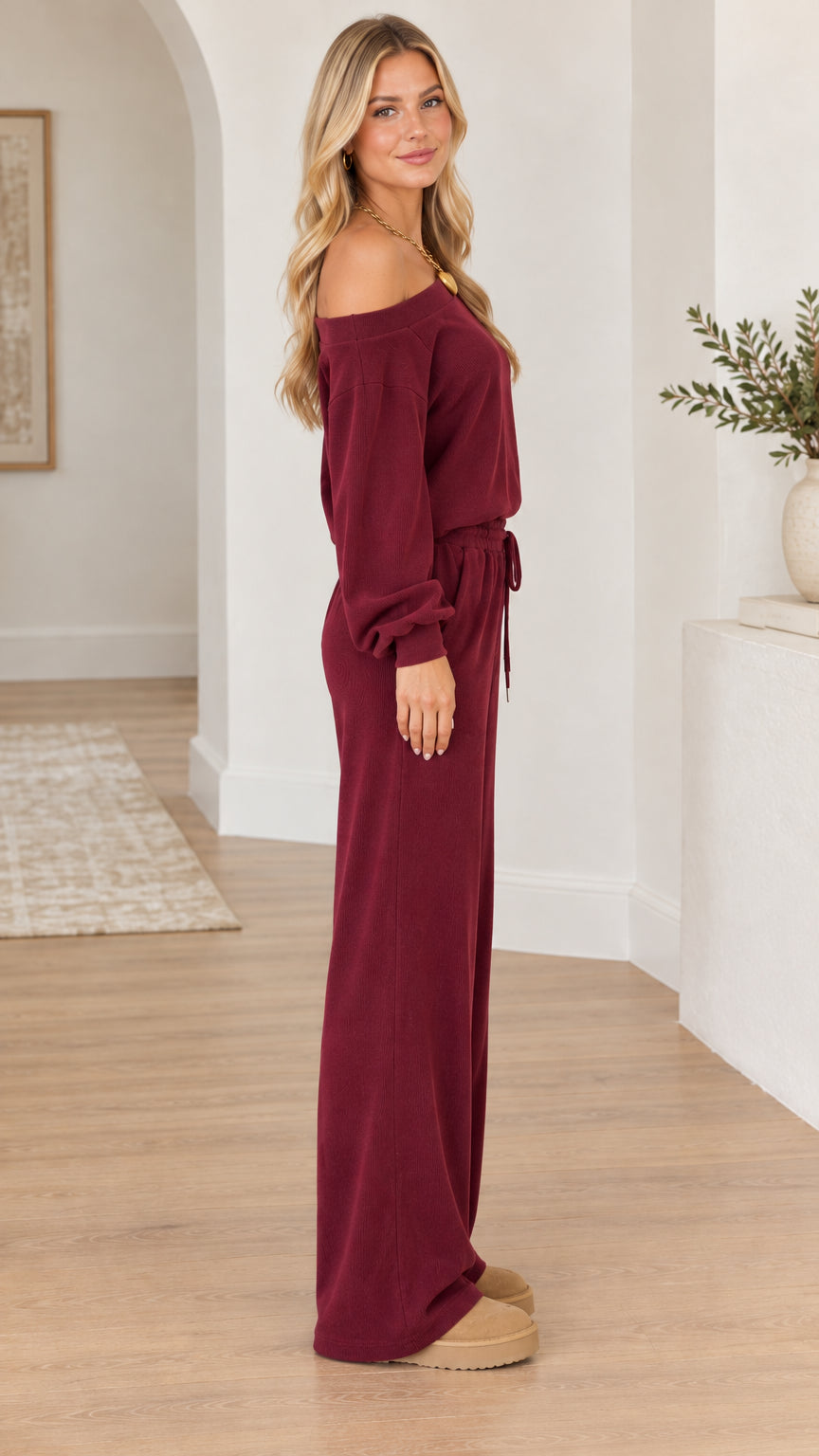 Side profile of woman modeling the burgundy two-piece loungewear set