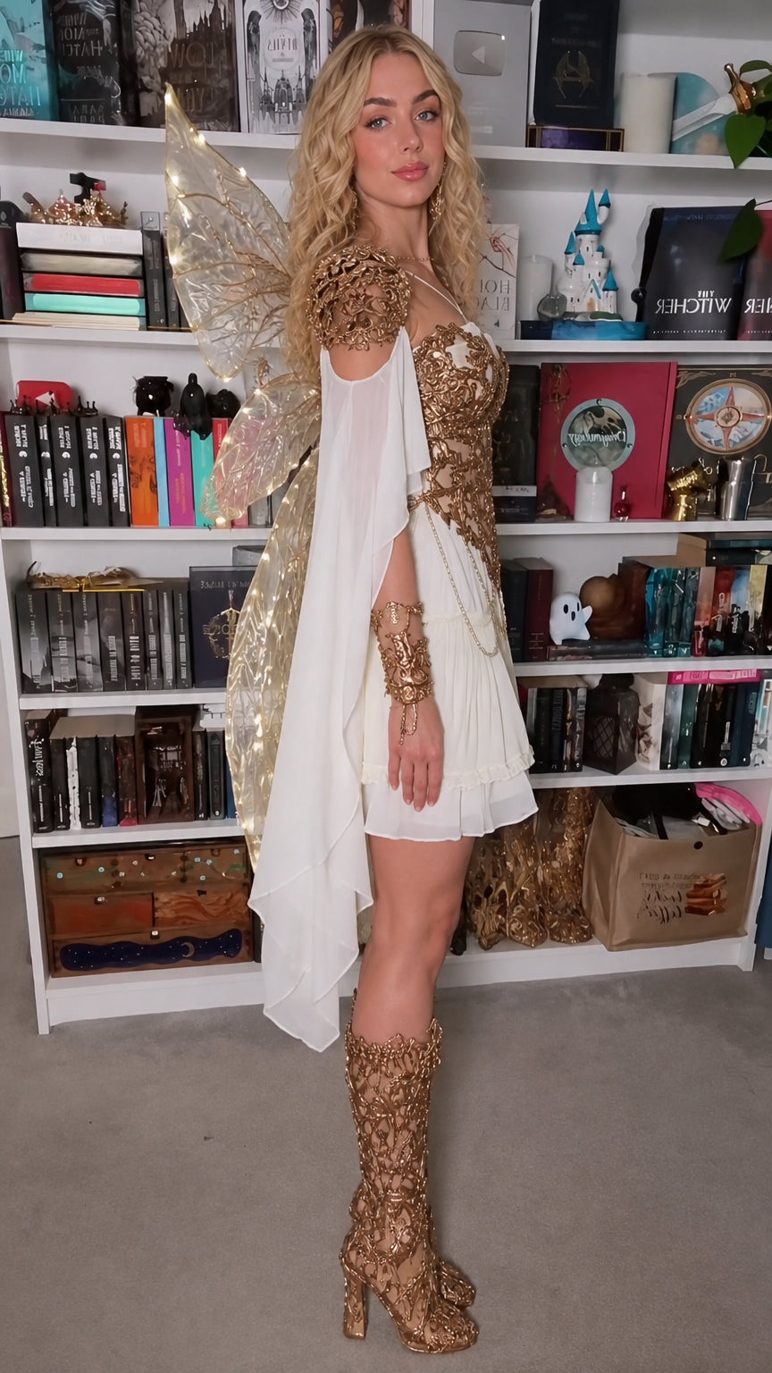 Side angle view of model wearing white fairy corset dress with flowing draped sleeves
