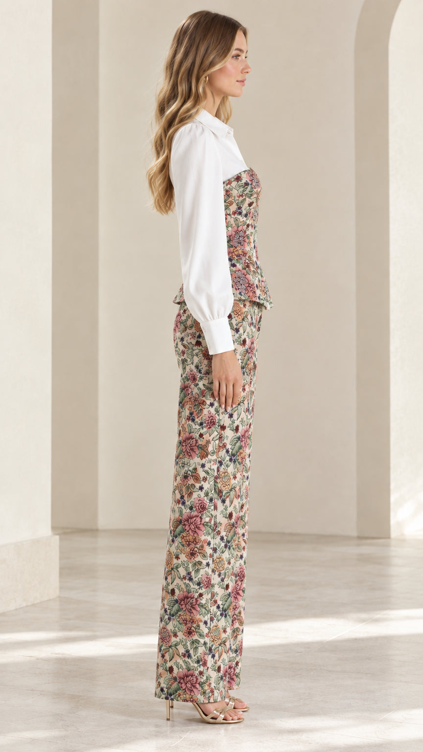 Side profile view of model wearing beige floral tapestry two-piece trouser set