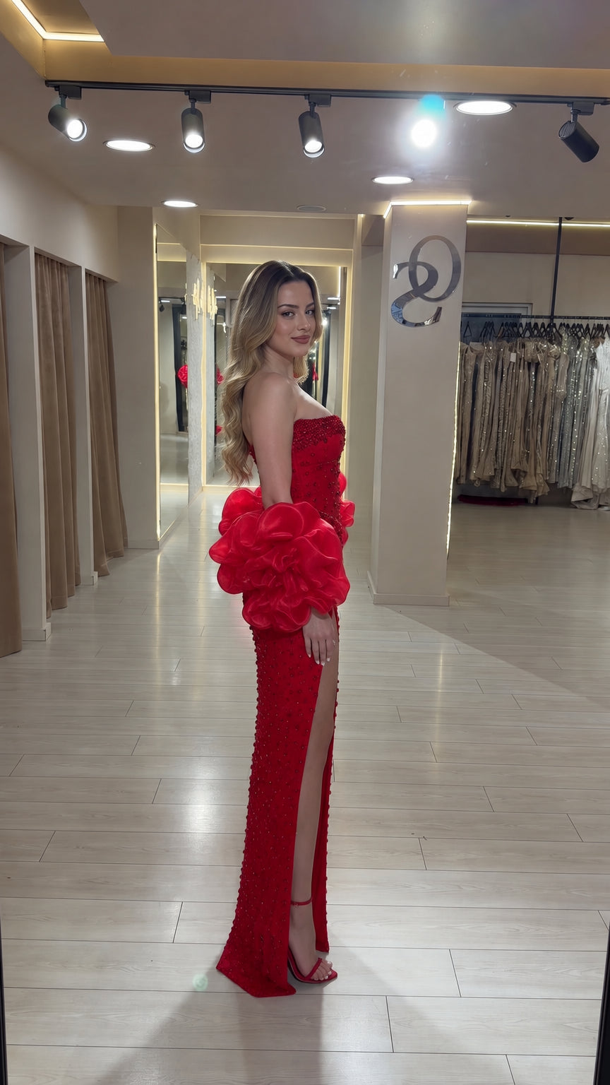 Side view of the red sequin off-shoulder evening gown showing its fitted silhouette