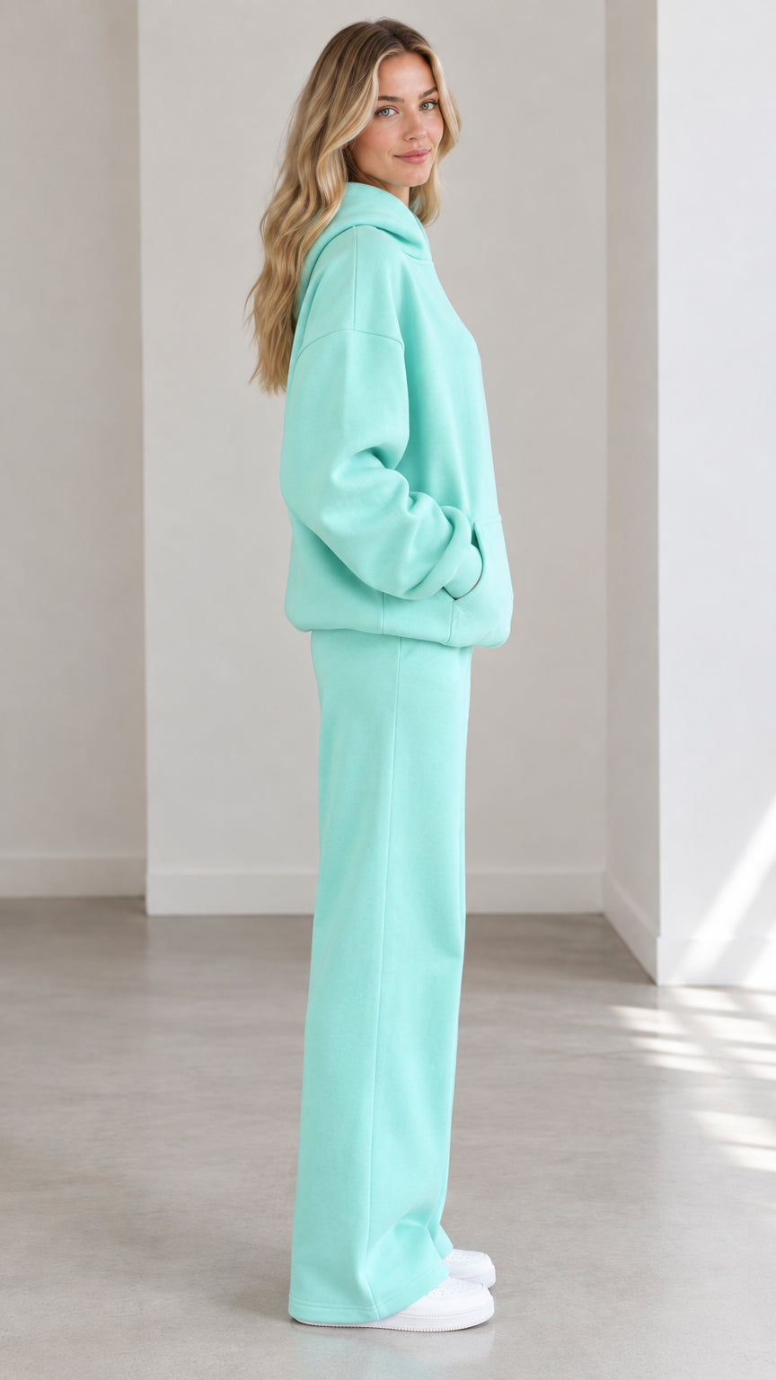 Side profile of woman wearing Mint Green 2-piece hoodie and lounge pants tracksuit