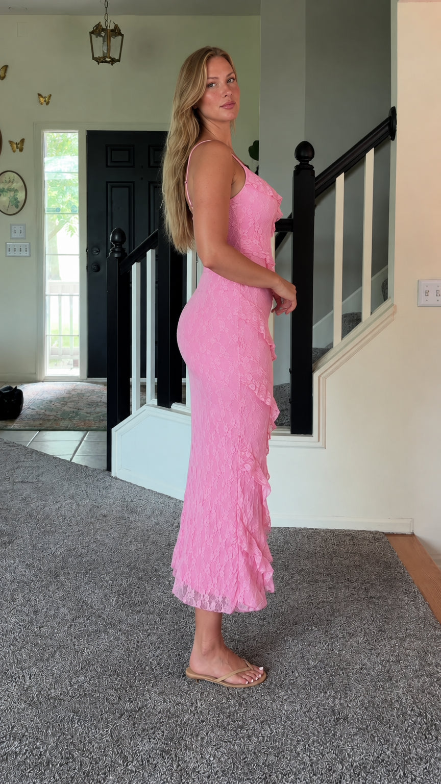 Side profile view of woman wearing pink lace ruffle cami dress