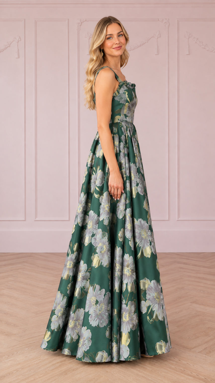 Side profile of woman modeling emerald green floral jacquard ballgown