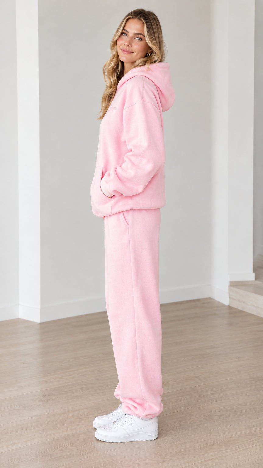 Side profile view of woman modeling the pink fleece loungewear set