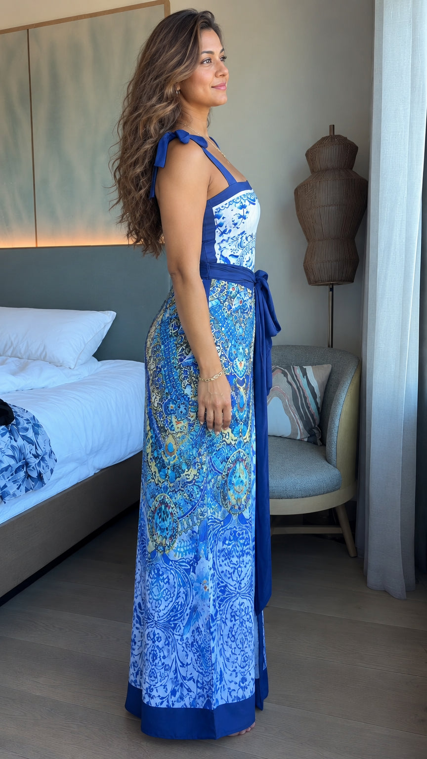 Side profile of woman in blue patterned tie-shoulder resort maxi dress