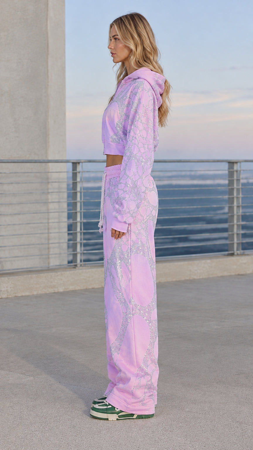 Side profile view of woman wearing lavender rhinestone tracksuit set