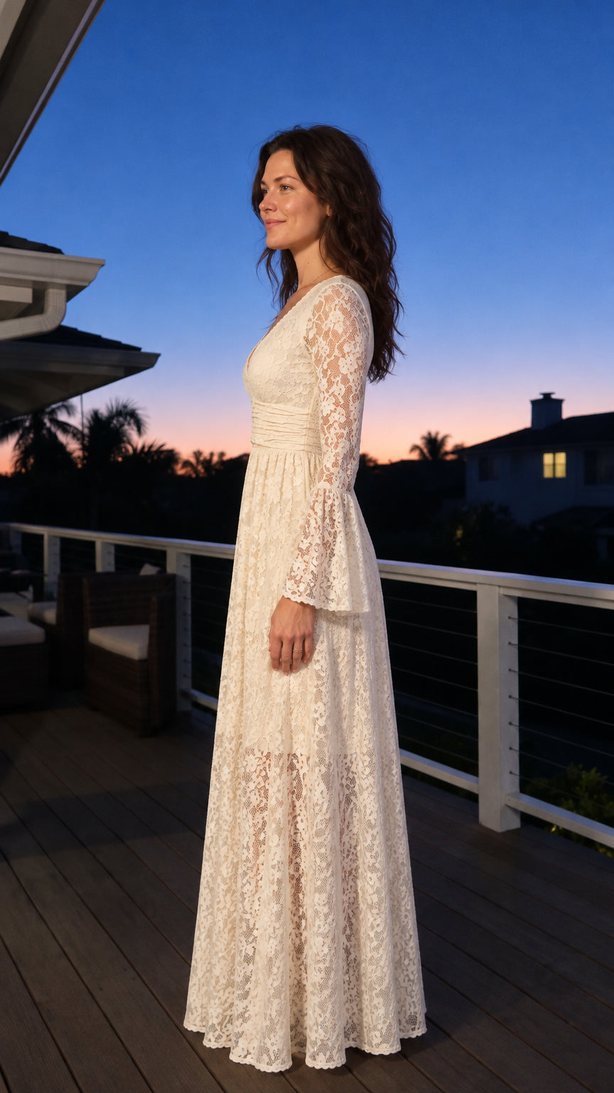 Side profile of woman in ivory floral lace maxi dress showing empire waist and flowing skirt