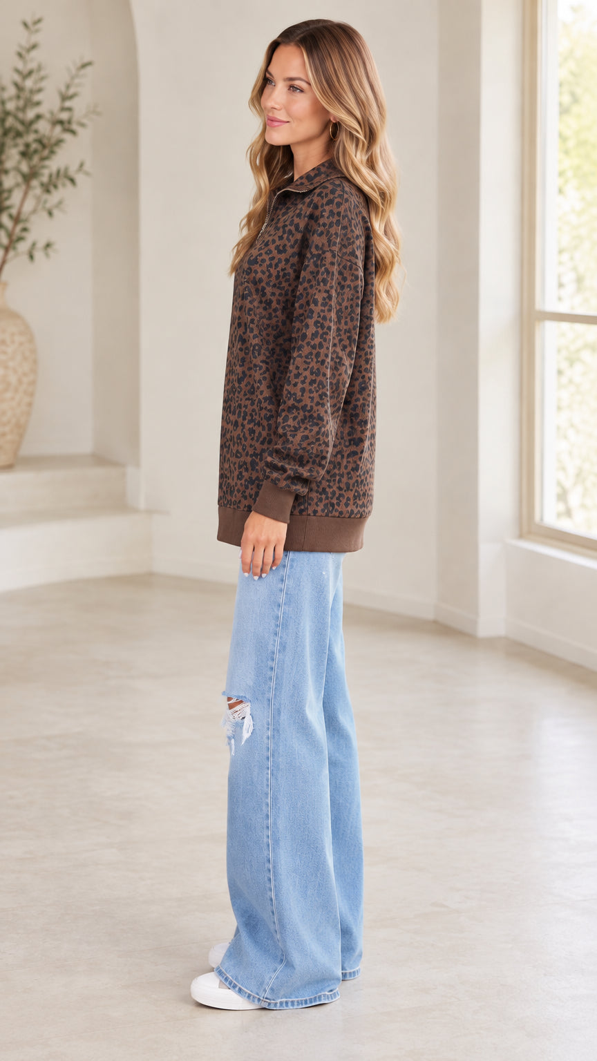 Side profile view of model wearing brown leopard print quarter-zip tunic sweatshirt