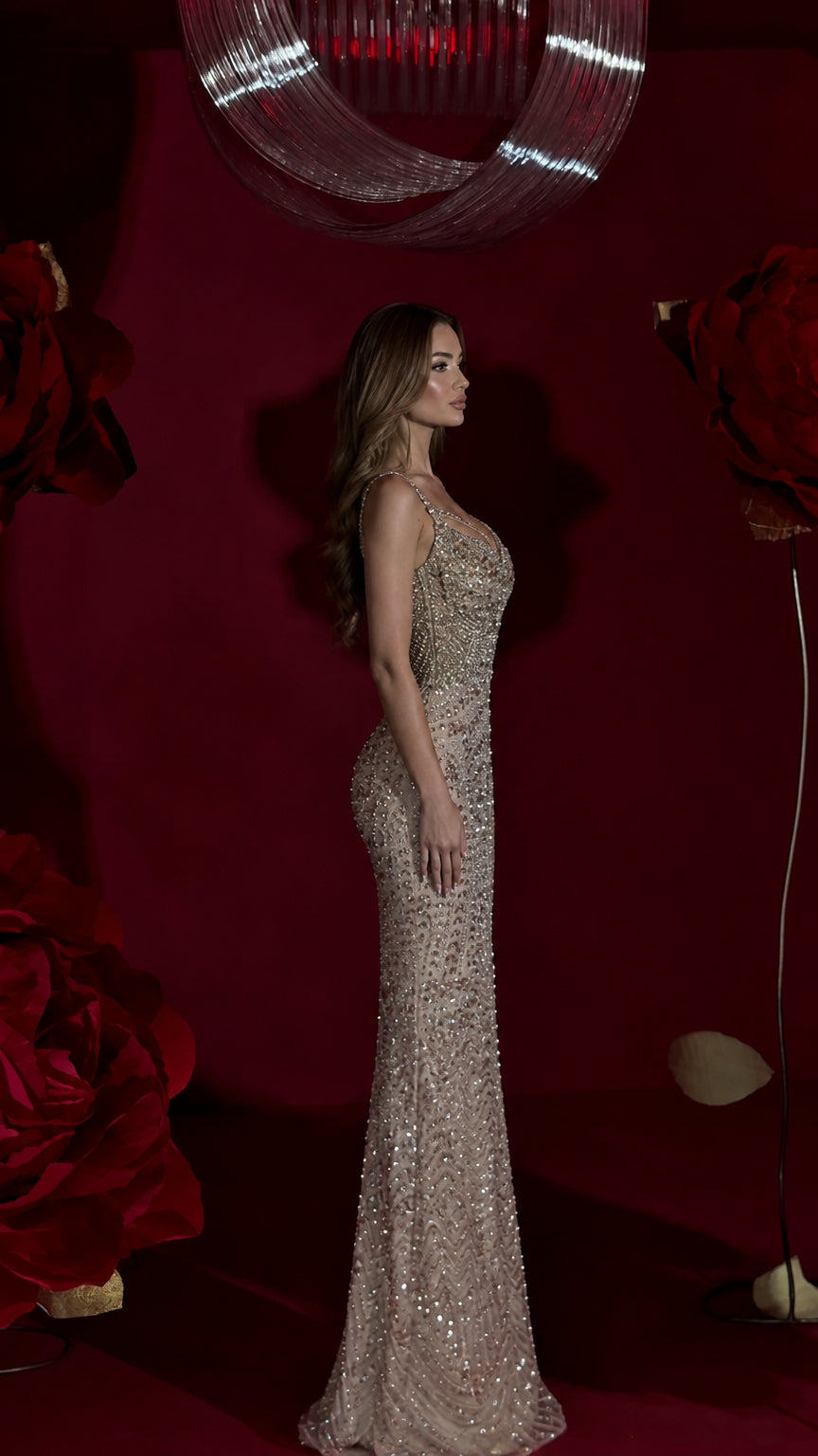 Side profile view of champagne embellished floor-length mermaid gown