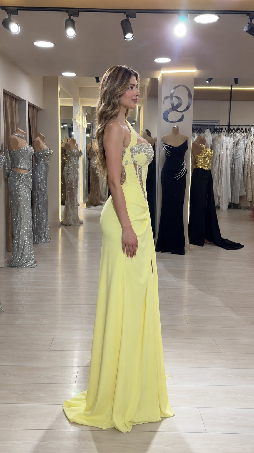 Pale yellow formal gown side profile showing draped silhouette and slit