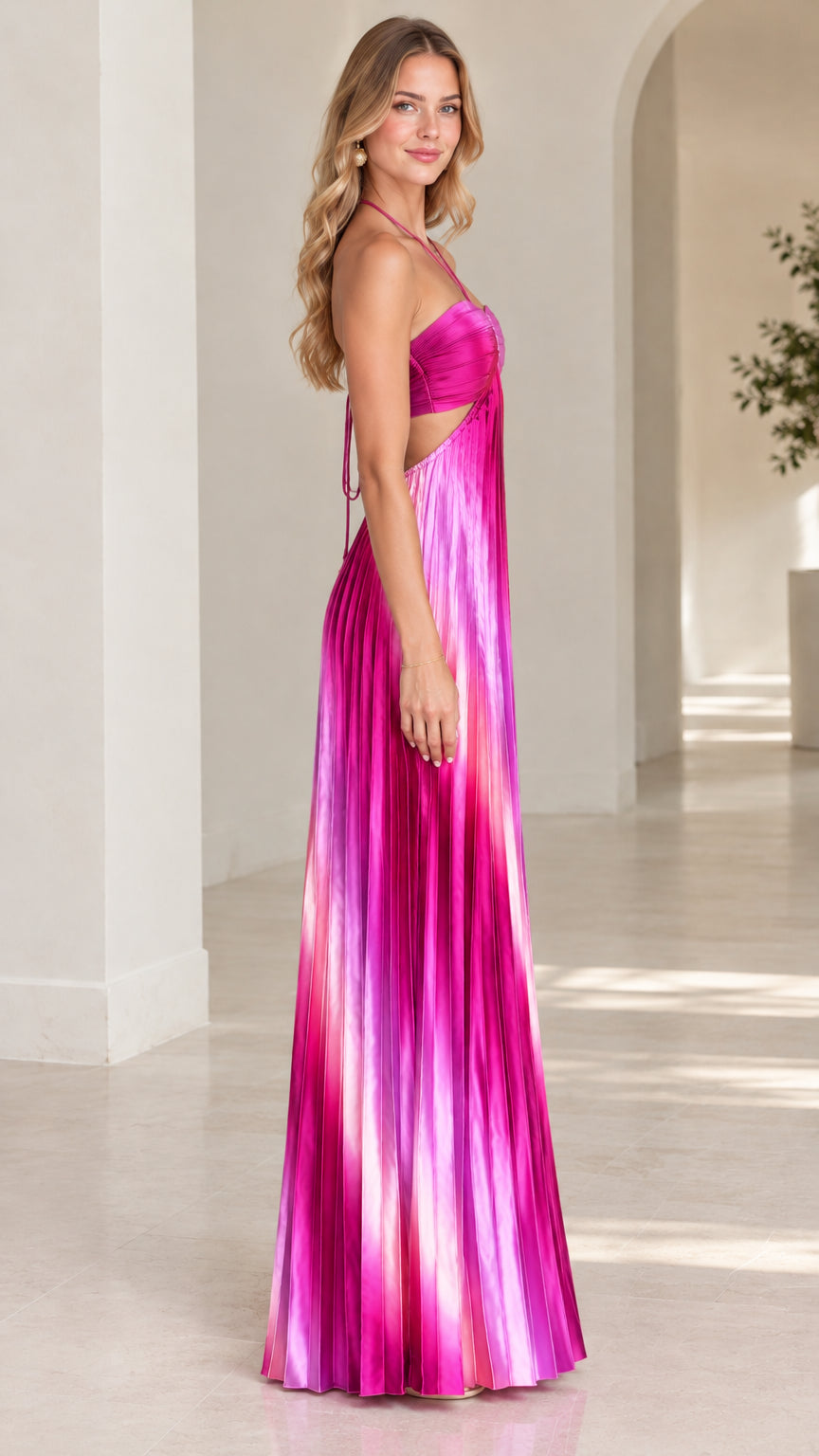 Side profile of model in fuchsia gradient pleated maxi dress with waist cutout