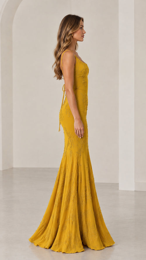 Side profile of Mustard Yellow beaded mermaid gown showing fitted silhouette