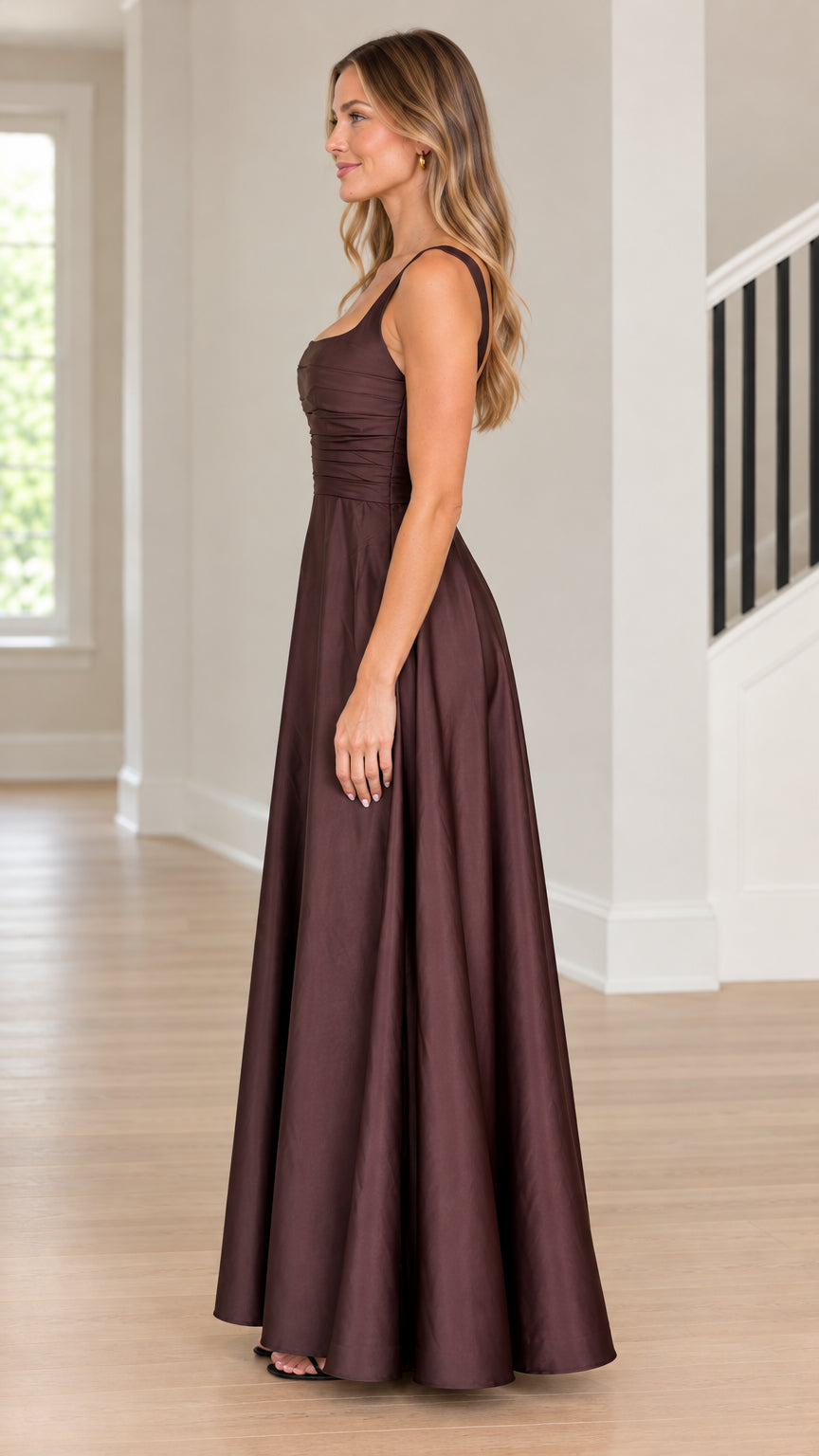 Model wearing chocolate brown sleeveless formal satin maxi dress side profile view