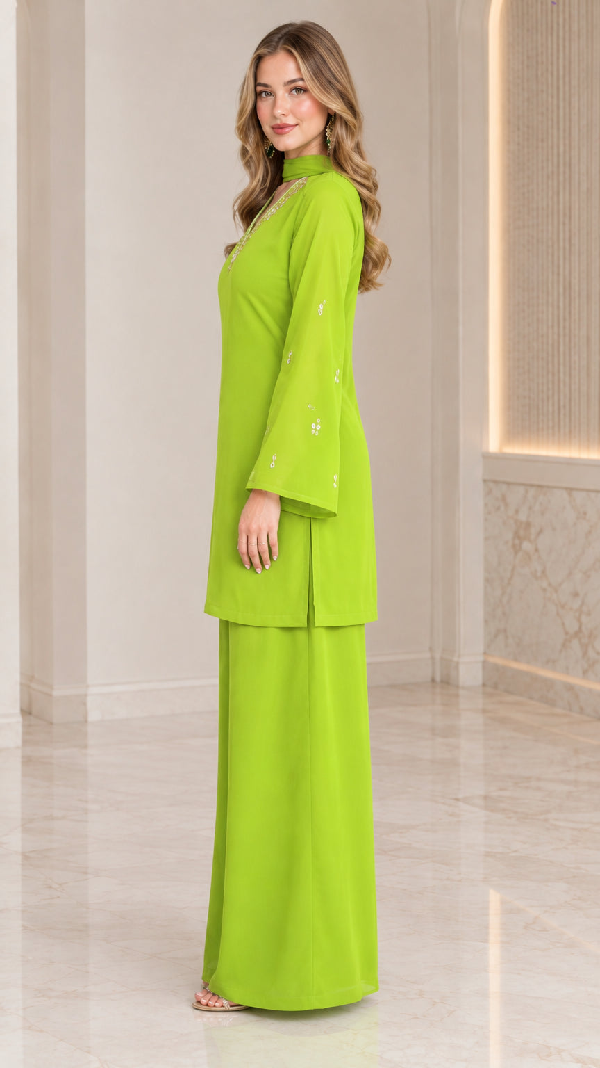 Side full-length view of model wearing lime green longline tunic and wide-leg trousers