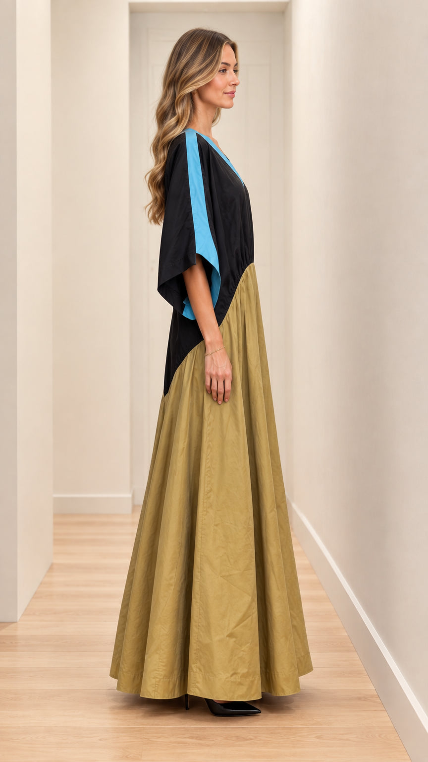 Side profile view of model wearing black and khaki batwing sleeve maxi dress
