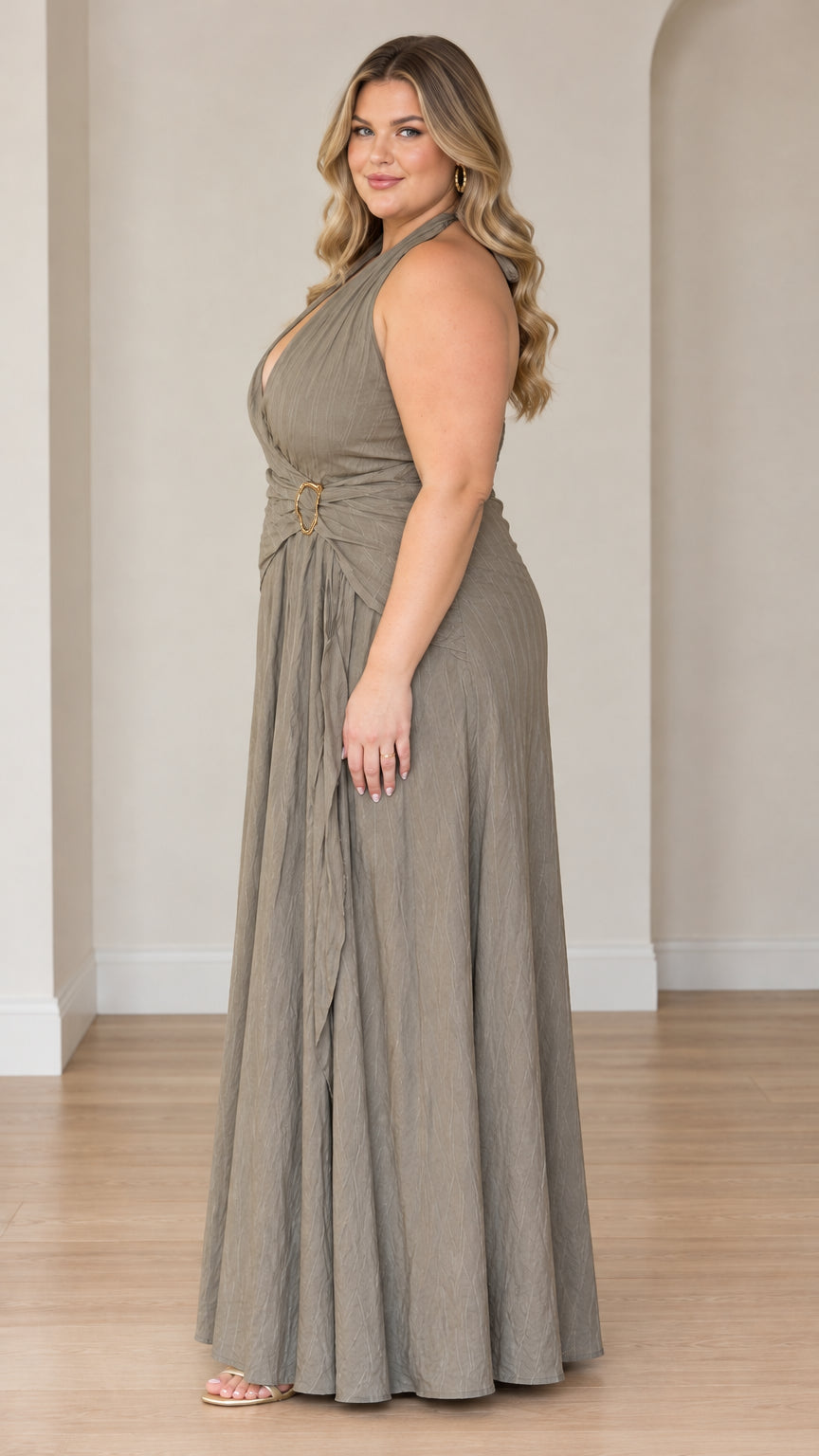 Plus size model in sage green halter neck evening gown - side profile view