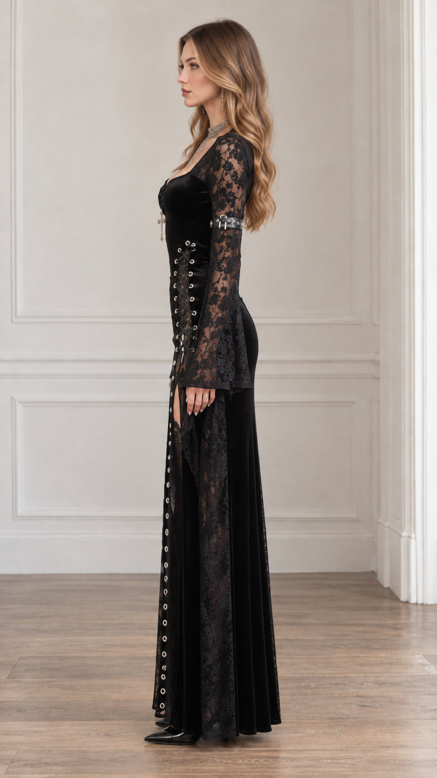 Side profile view of woman modeling the black gothic velvet dress with sheer lace inserts