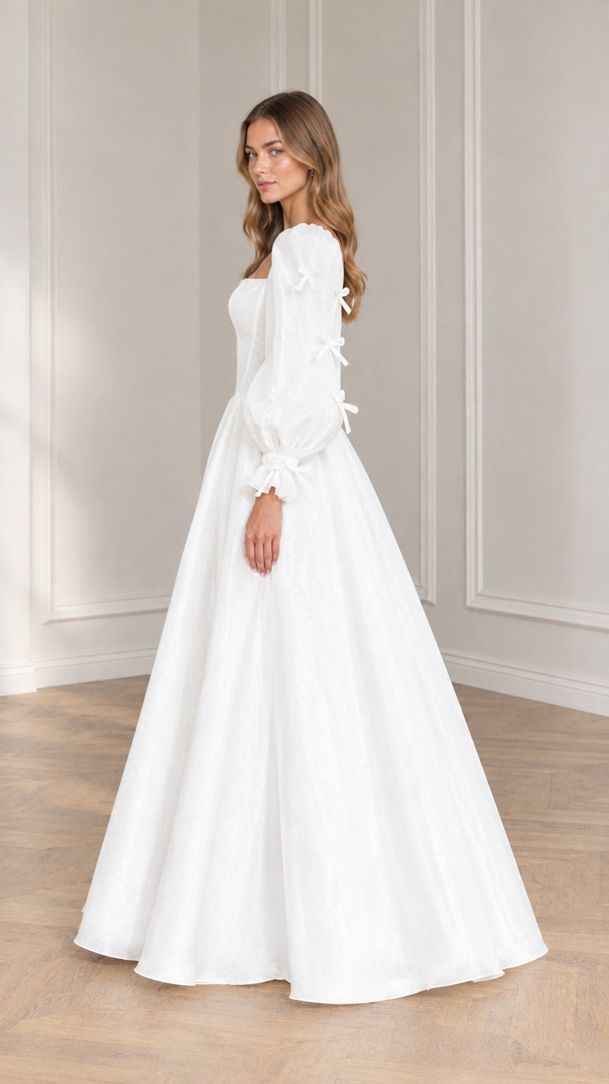 Side profile view of model wearing white puff sleeve formal ballgown dress