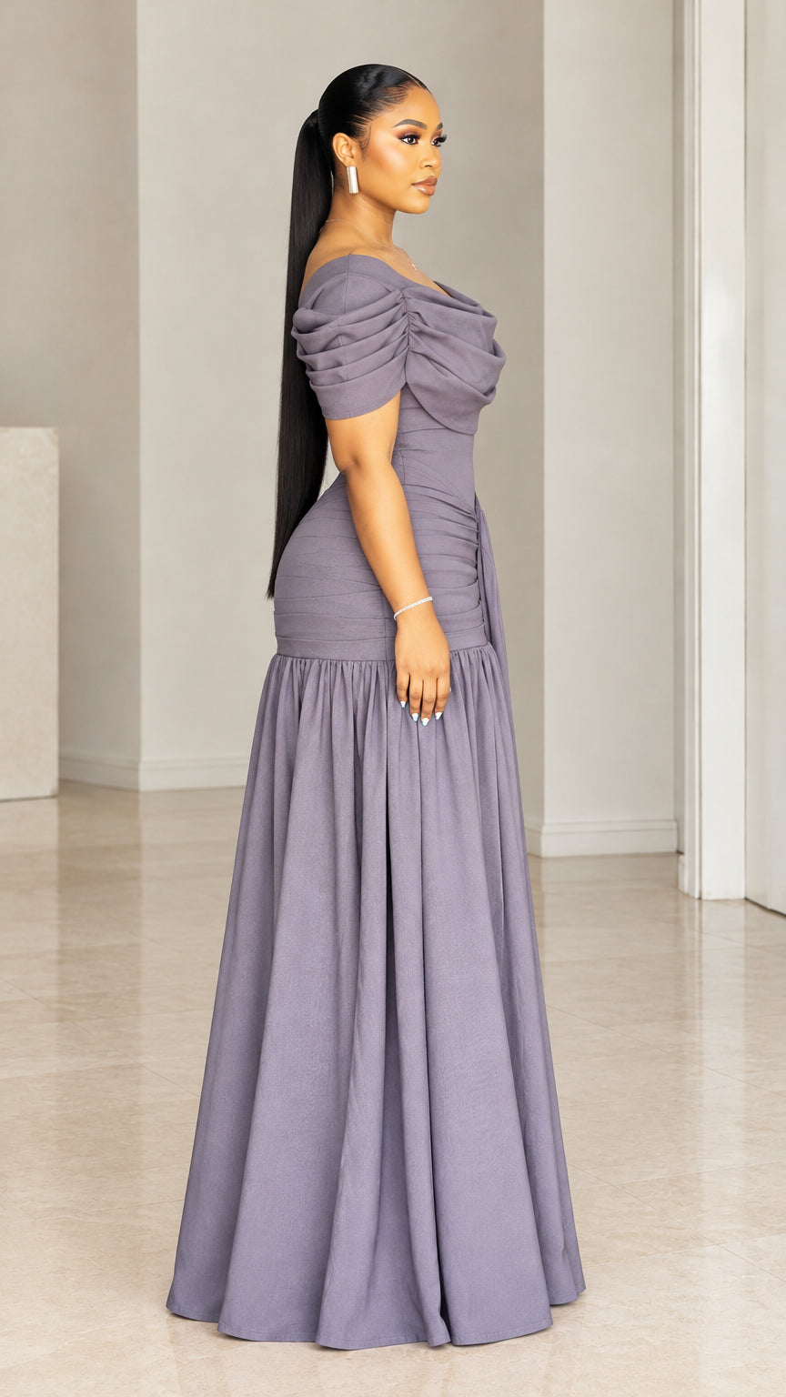 Side profile view of woman modeling dusty purple draped maxi dress with gathered skirt
