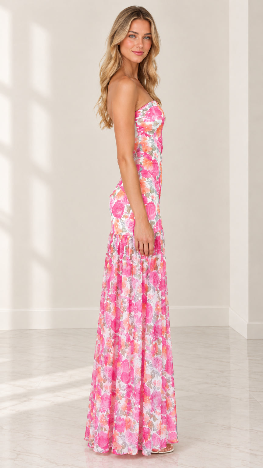 Side profile view of model wearing pink floral strapless drop-waist maxi dress