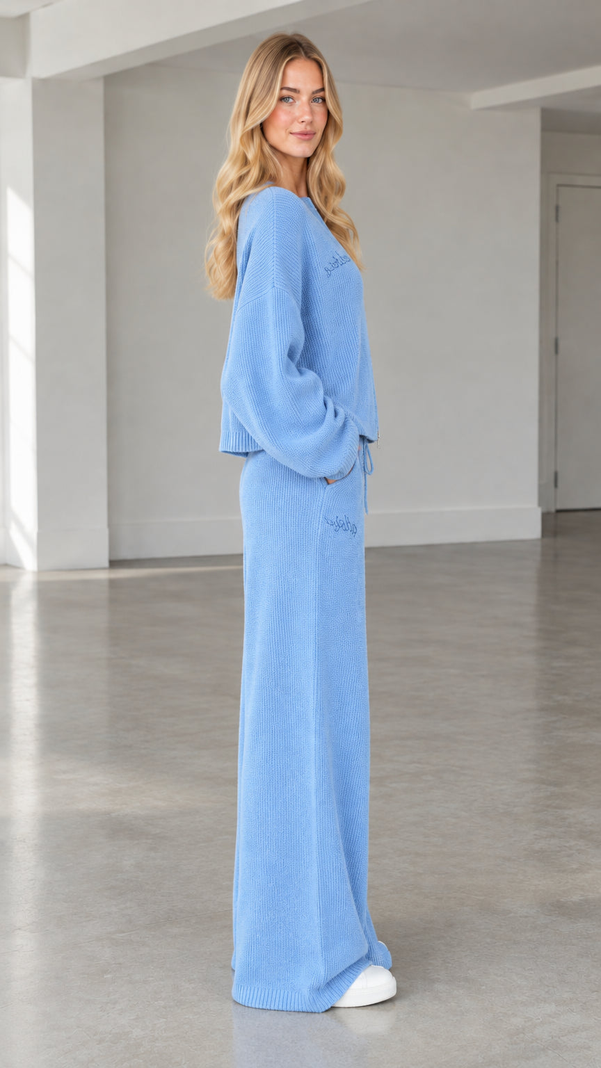 Side profile view of woman wearing light blue ribbed knit matching set