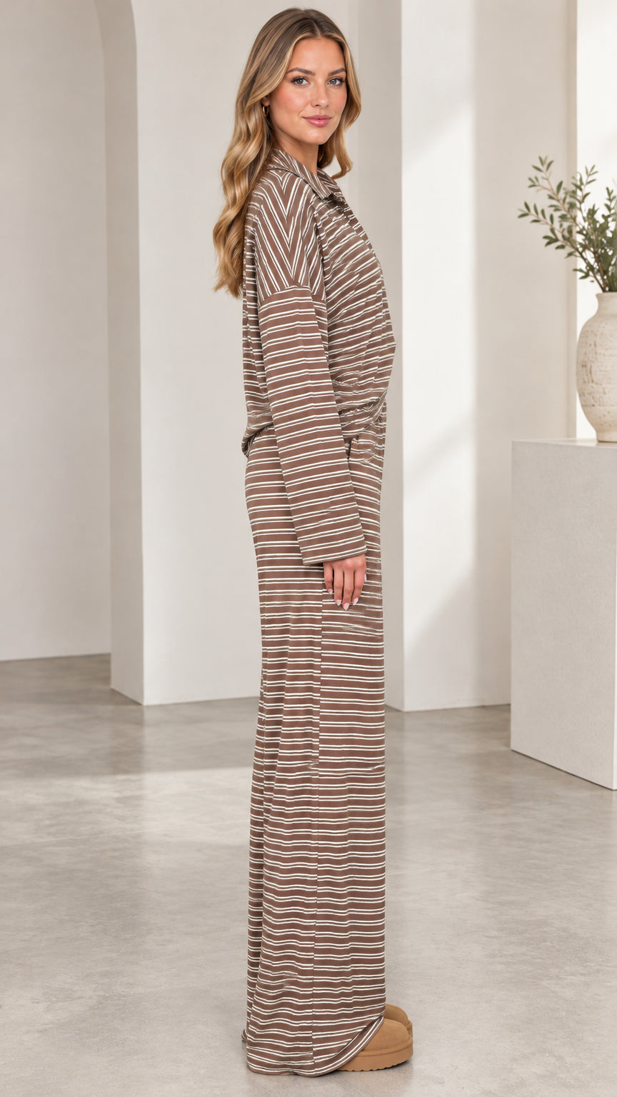 Side profile view of model wearing brown striped two-piece lounge set