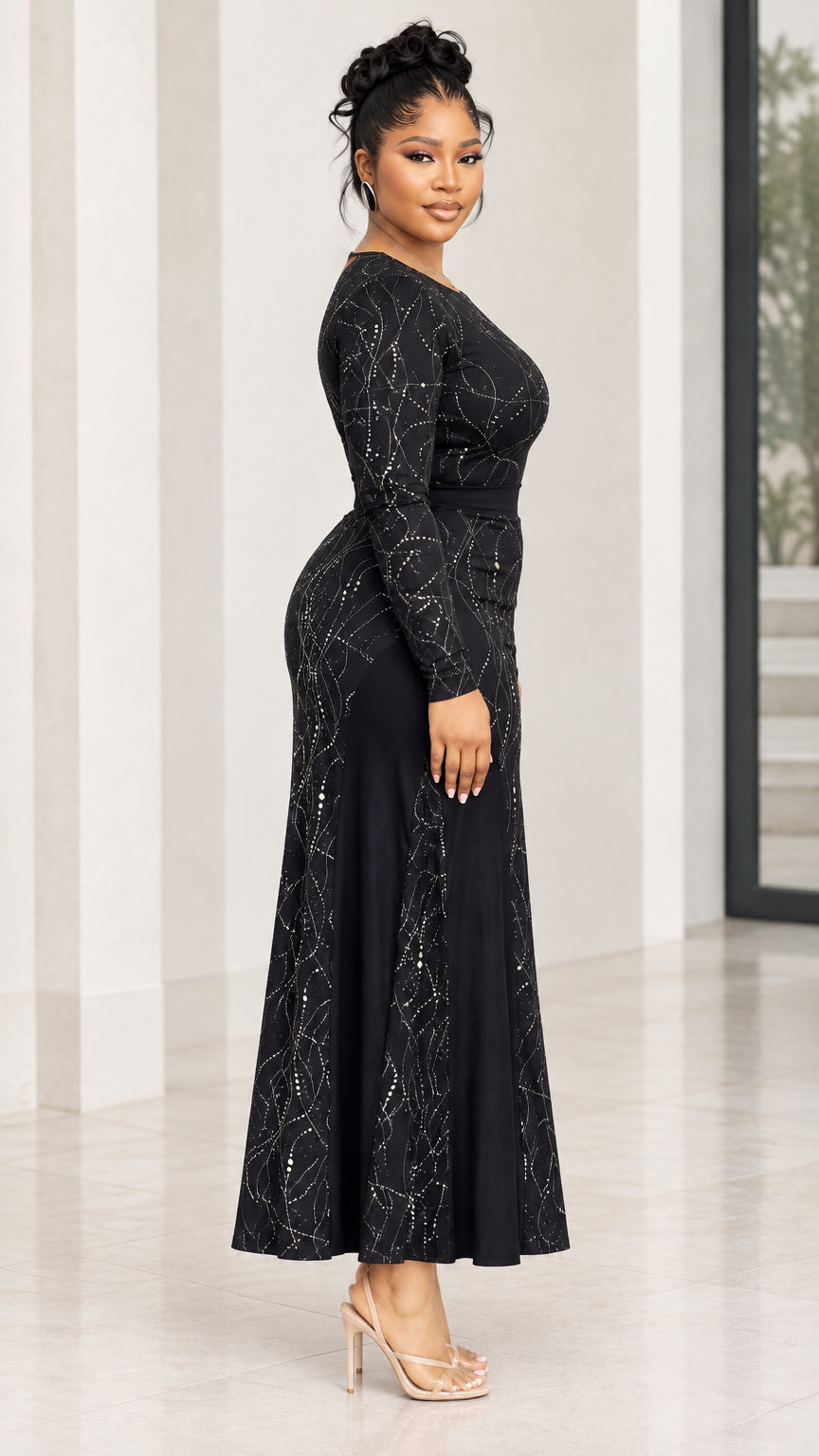 Side profile view of model in black long sleeve rhinestone maxi dress