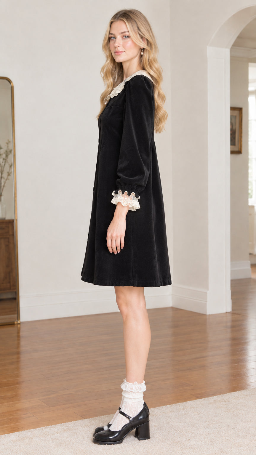 Side profile view of black velvet long sleeve dress with lace cuffs