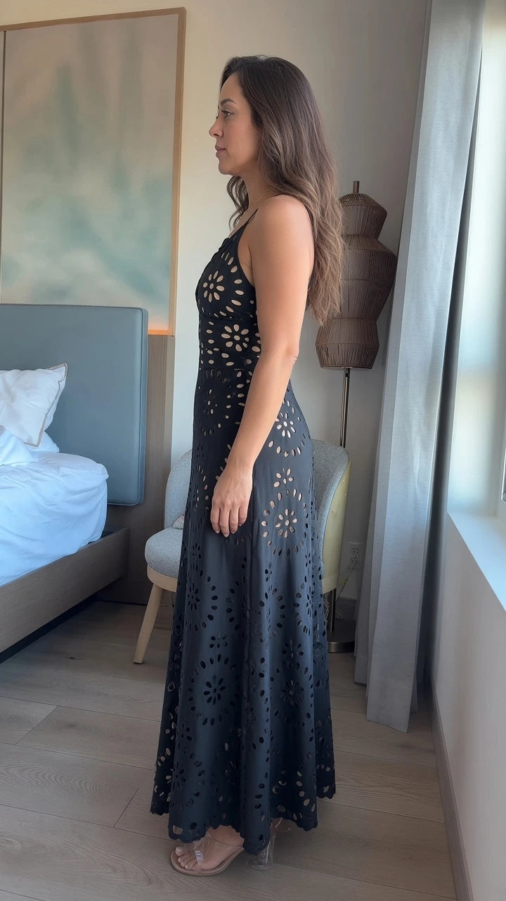 Side profile view of woman wearing Black floral cutout scalloped maxi dress