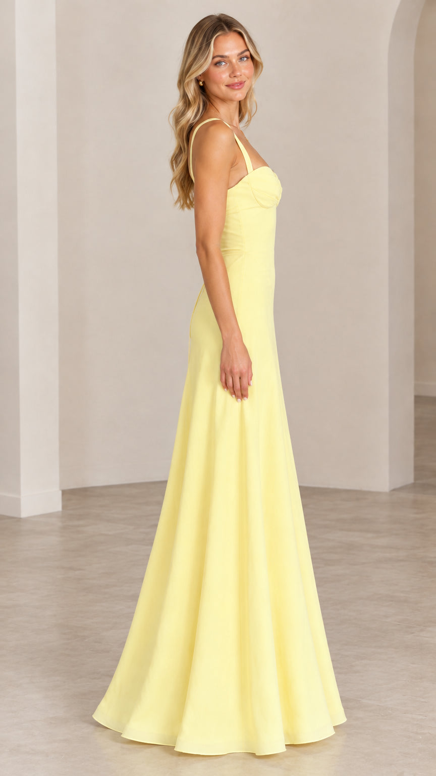 Side profile view of model showcasing the silhouette of the yellow evening gown