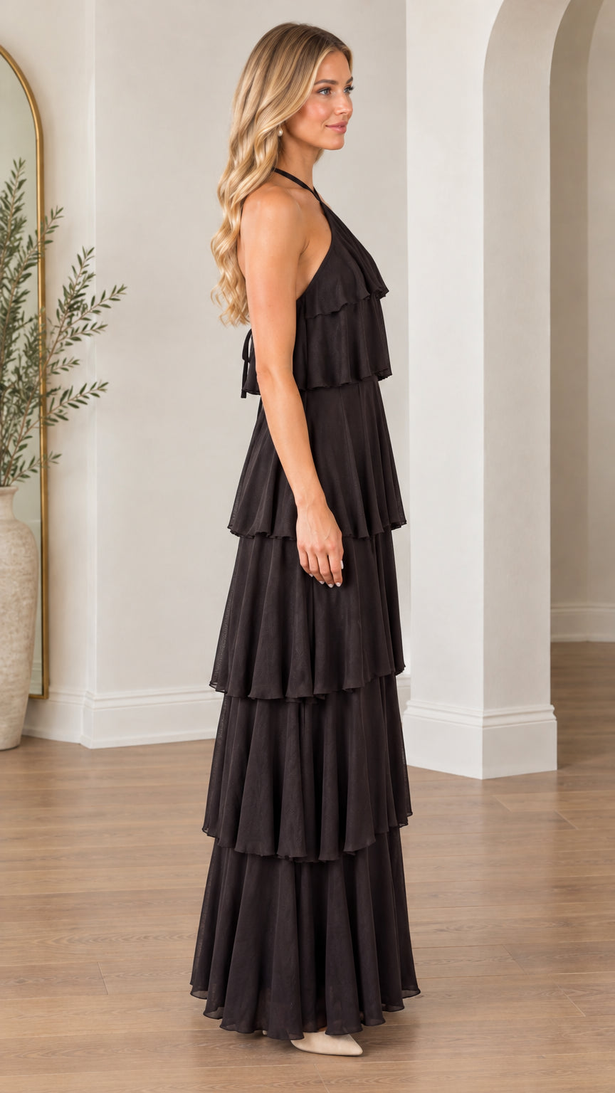 Side angle of model wearing black halter tiered maxi dress