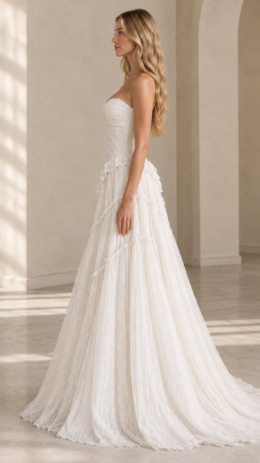 Side profile view of ivory strapless A-line tiered evening dress