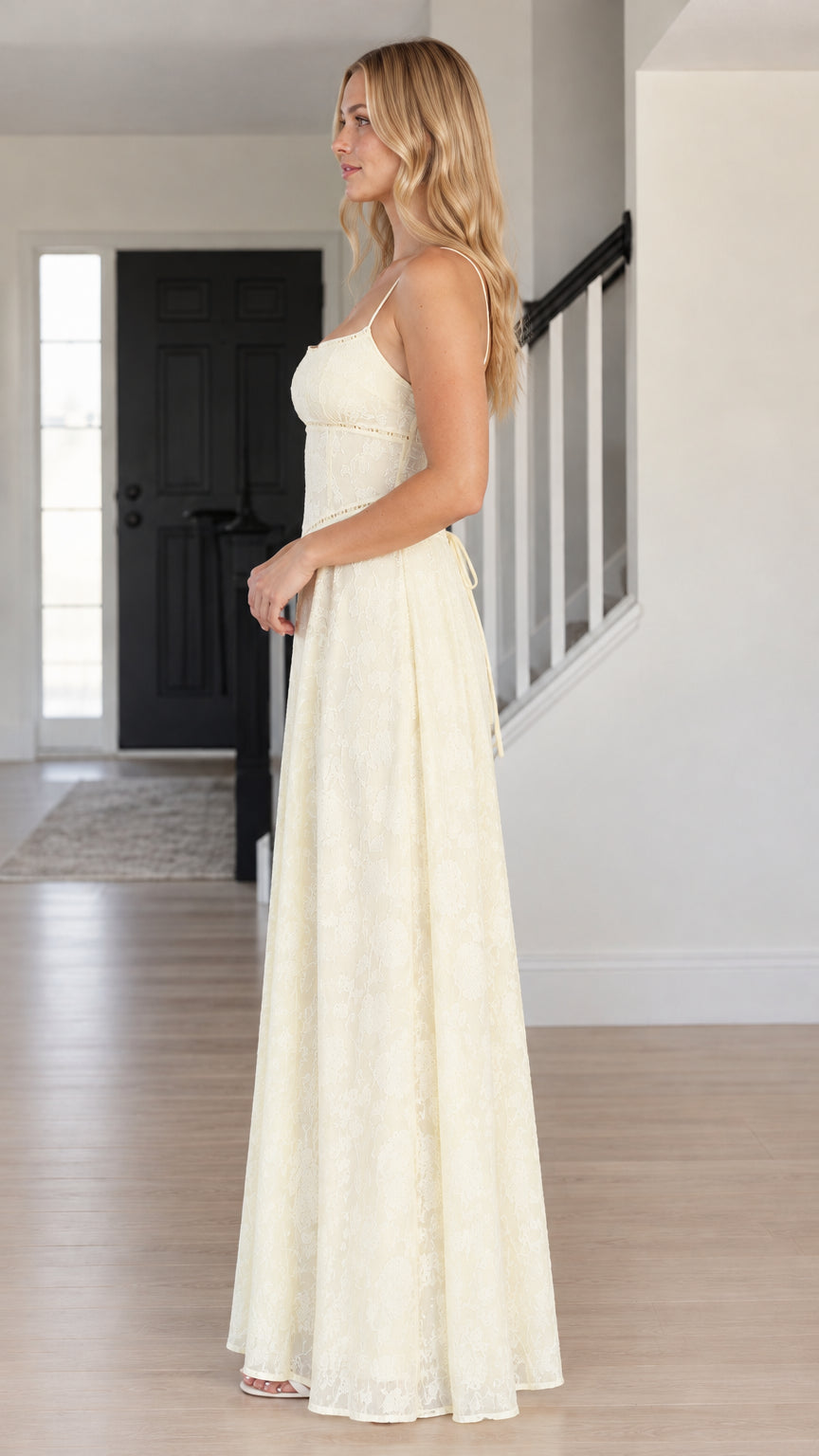 Side profile view of woman wearing ivory lace evening gown