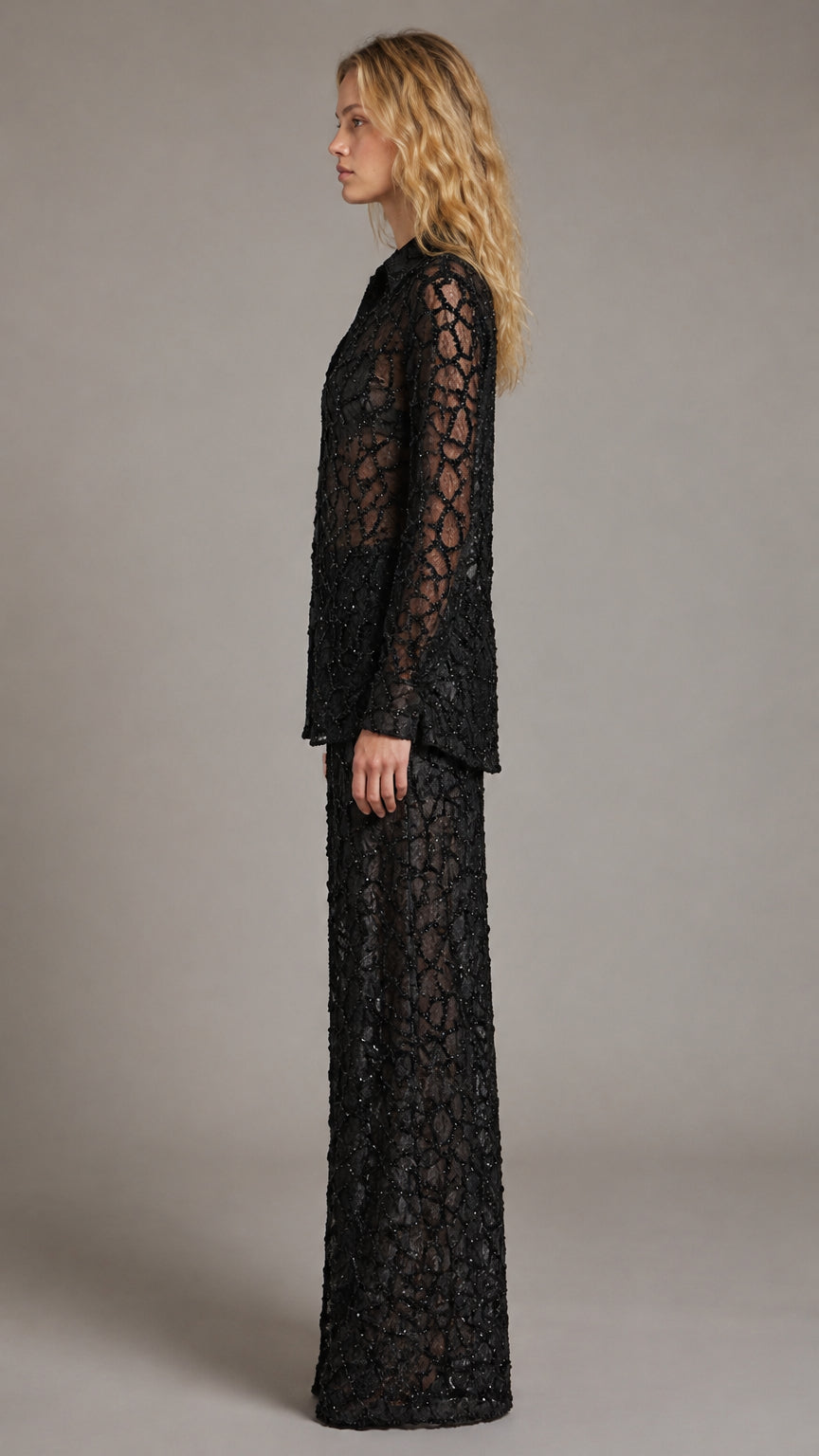 Side profile view of model showcasing black sequin two-piece pant set