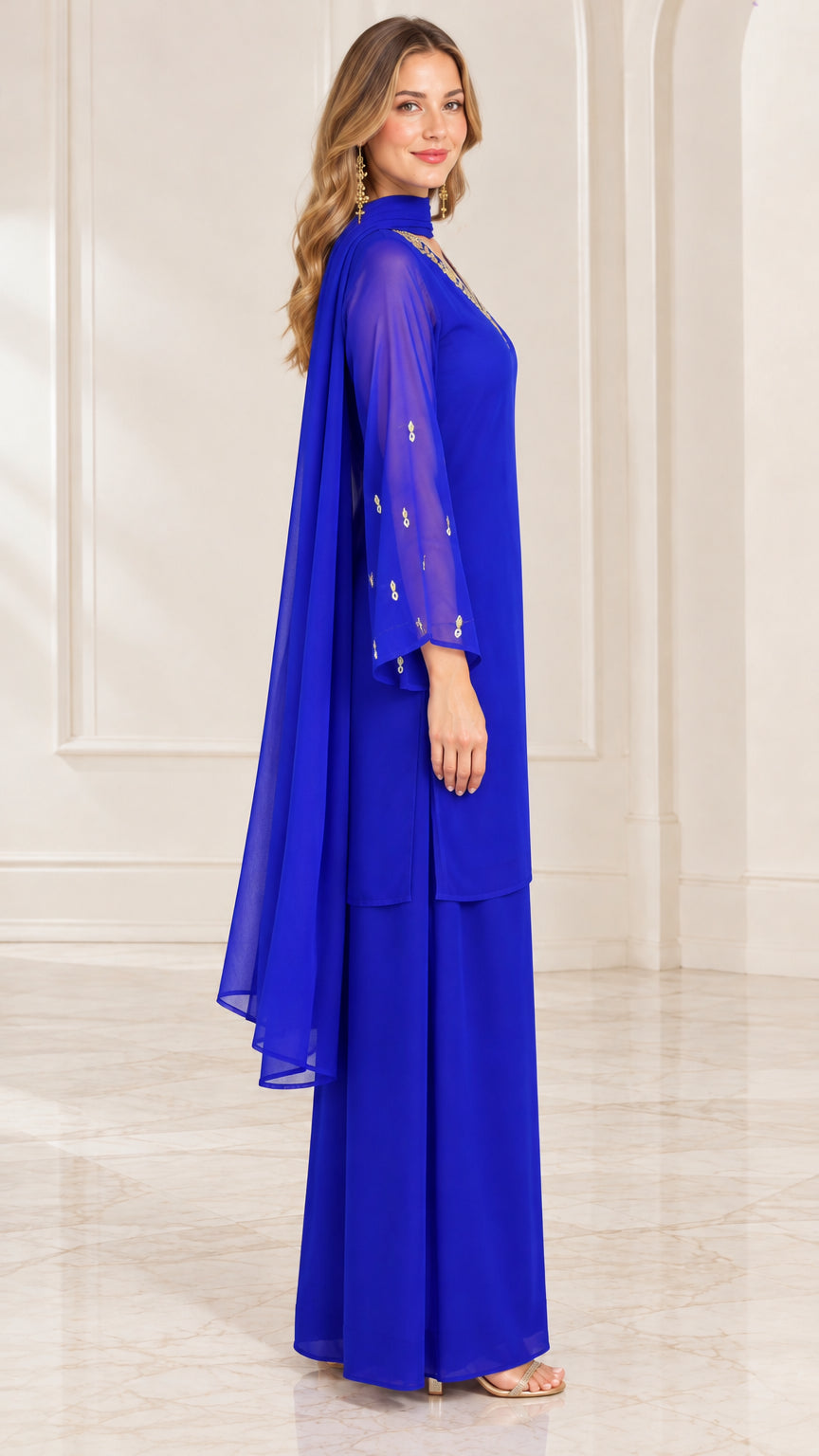 Side profile view of royal blue chiffon formal pant set showing sheer sleeves and draped scarf