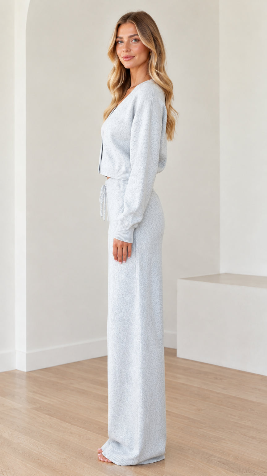 Side profile view of woman wearing Light Blue cropped cardigan and wide leg pants