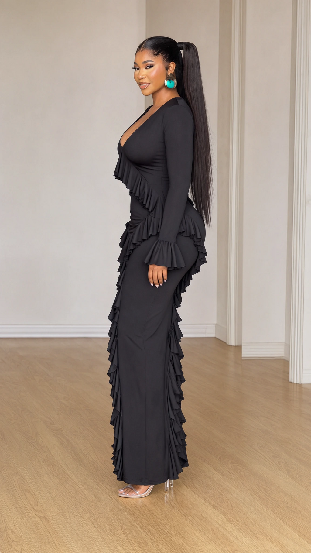 Side profile view of black long sleeve ruffle maxi dress highlighting silhouette