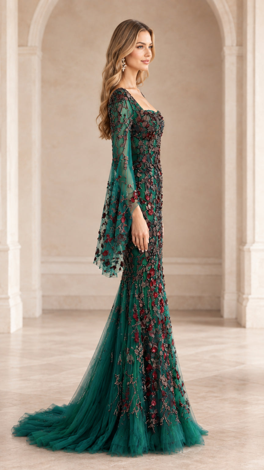 Side profile view of emerald green beaded mermaid evening dress showing flowing silhouette and train