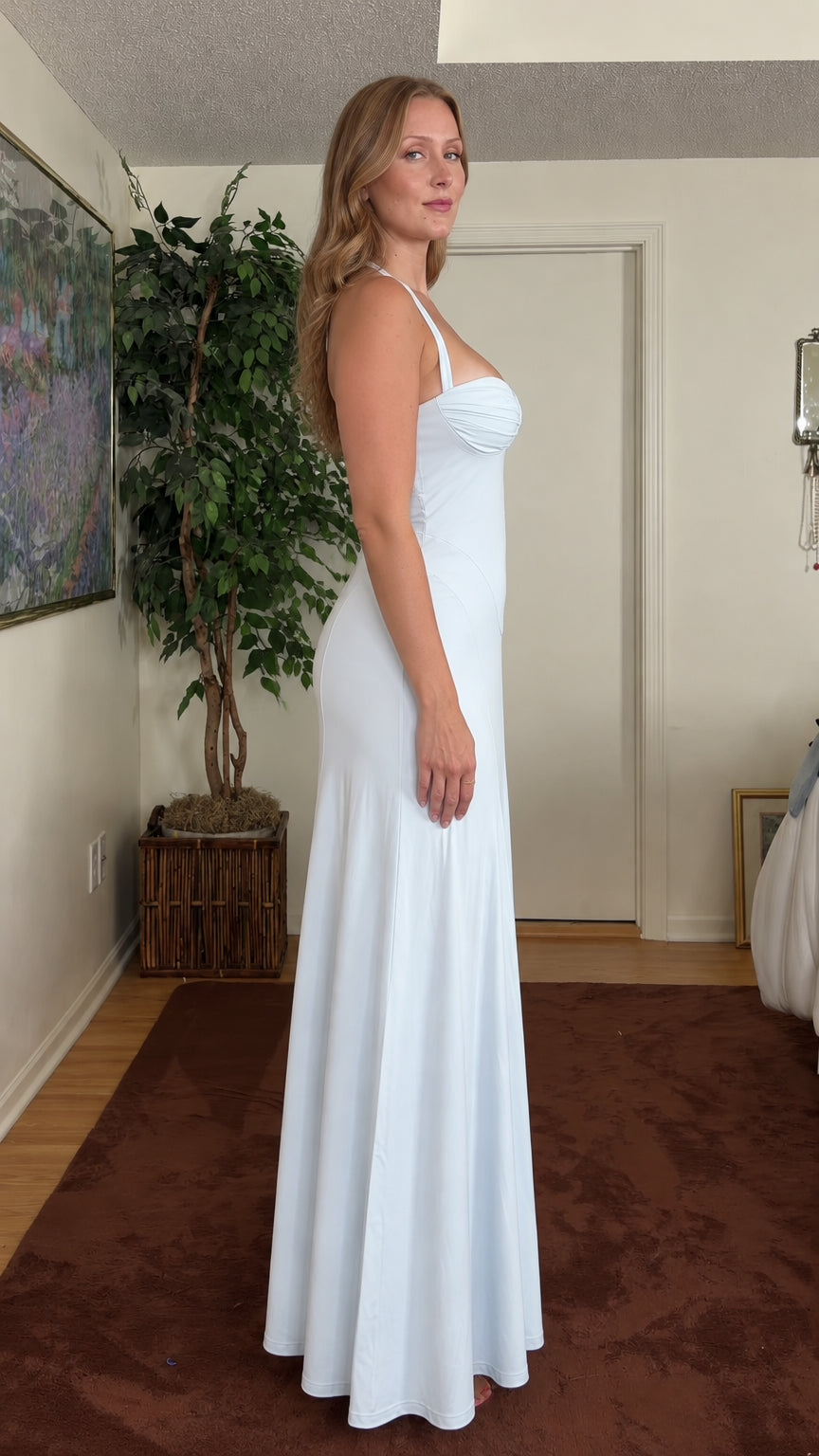 Side profile of model in light blue sweetheart neckline maxi dress