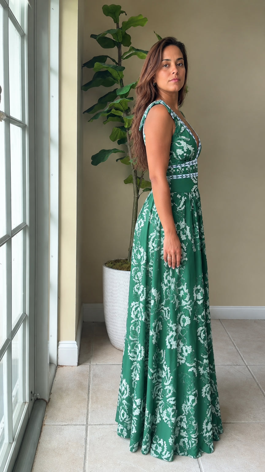 Side profile of woman wearing emerald green floral print maxi dress